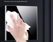 Person cleaning a BONDA™ Smart WiFi Touch Switch with a cloth, showcasing its flat mirror design.